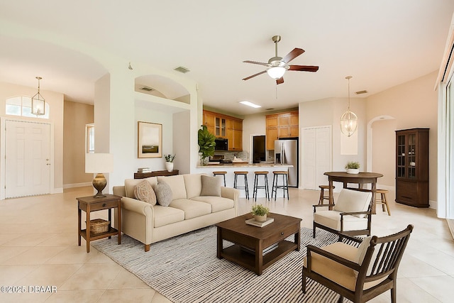 1832 Afshin Ct, Port Orange, FL 32128 - living area featuring light tile patterned flooring, ceiling fan, and arched walkways