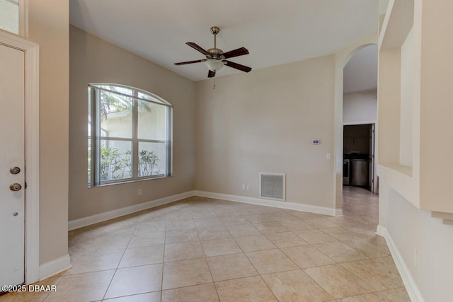 1832 Afshin Ct, Port Orange, FL 32128 - empty room with arched walkways, ceiling fan, and light tile patterned floors