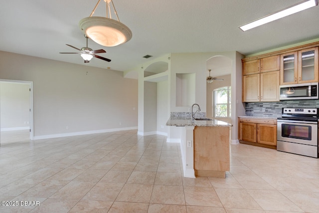 1832 Afshin Ct, Port Orange, FL 32128 - kitchen featuring appliances with stainless steel finishes, ceiling fan, backsplash, and open floor plan