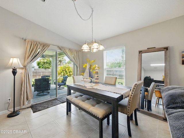 1354 Vandalia Ave SE, Palm Bay, FL 32909 - dining room featuring a chandelier, light tile patterned floors, vaulted ceiling, and baseboards