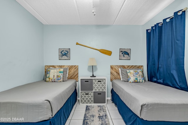 3800 S S Atlantic Ave Unit 105, Daytona Beach Shores, FL 32118 - bedroom featuring light tile patterned floors and a textured ceiling