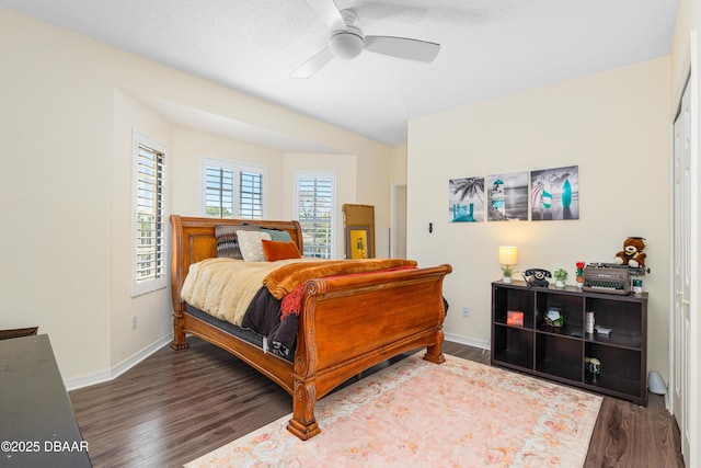 bedroom featuring a ceiling fan, wood finished floors, and baseboards