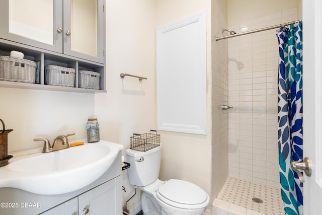 bathroom featuring toilet, vanity, and a tile shower