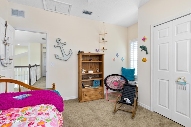 bedroom featuring a closet, visible vents, carpet flooring, and baseboards