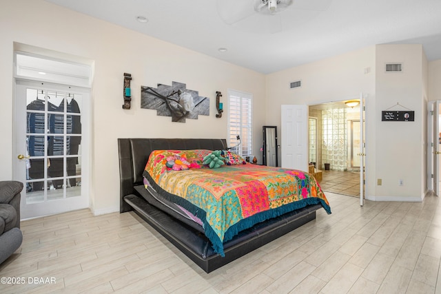 bedroom featuring visible vents, baseboards, and wood finished floors