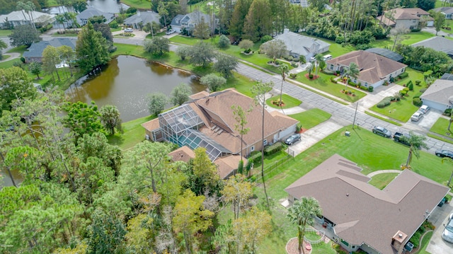 birds eye view of property with a residential view and a water view