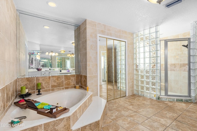 bathroom featuring tile walls and a textured ceiling