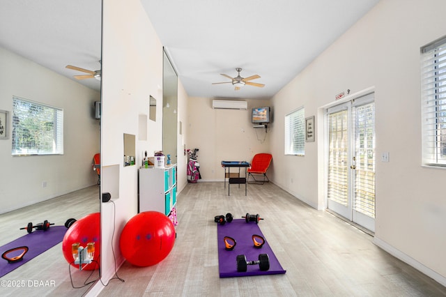 game room featuring an AC wall unit, a ceiling fan, and wood finished floors