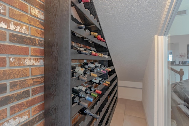 wine area featuring tile patterned floors and visible vents