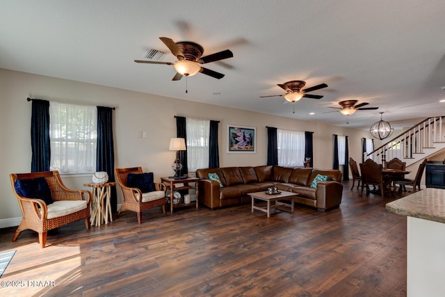 living room with a ceiling fan, stairway, and a healthy amount of sunlight