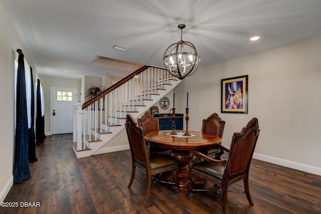 dining room featuring stairs, wood finished floors, visible vents, and a chandelier