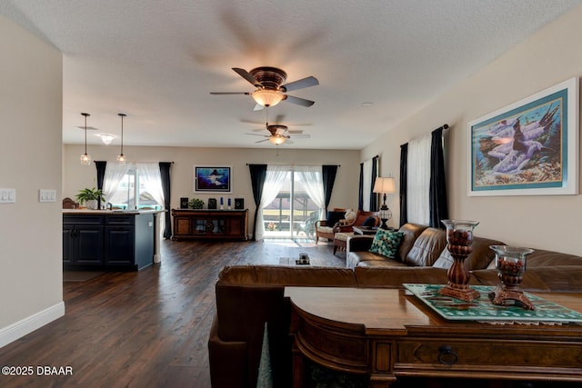 living room with dark wood finished floors, a textured ceiling, plenty of natural light, and ceiling fan