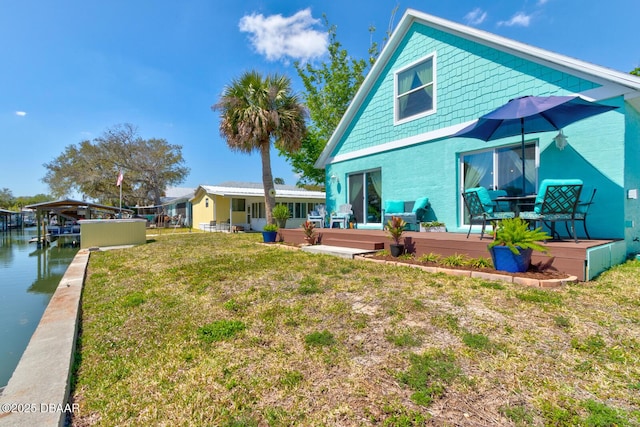 rear view of house with a yard