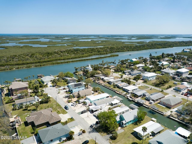 drone / aerial view with a residential view and a water view