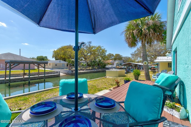 view of patio featuring a balcony and a water view