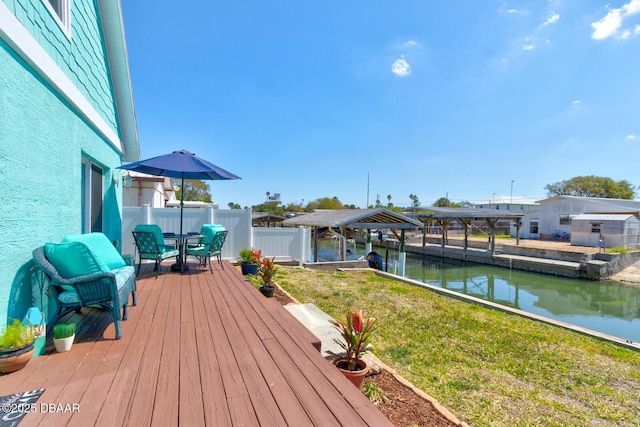 deck with fence and a water view