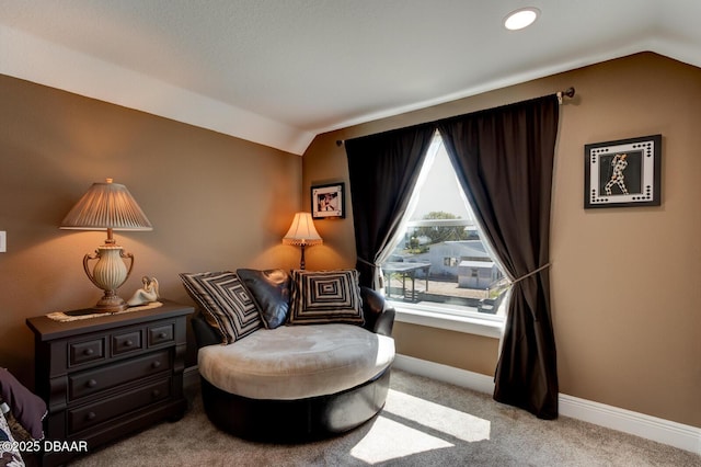 sitting room featuring carpet floors, baseboards, and vaulted ceiling