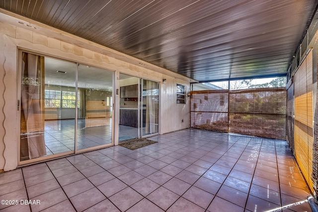 unfurnished sunroom with wooden ceiling