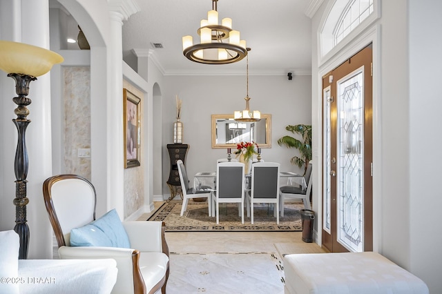 dining space featuring crown molding and a chandelier