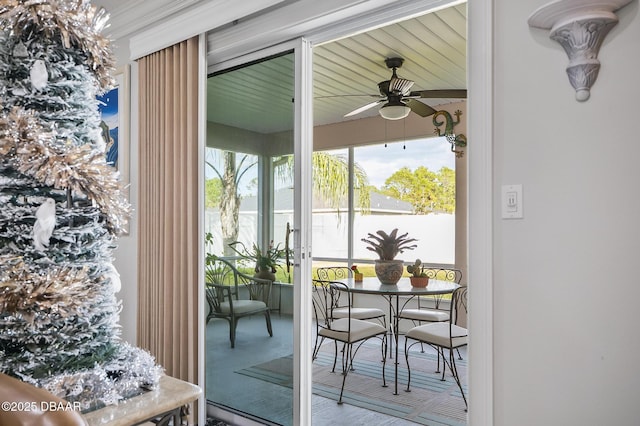 doorway to outside featuring ceiling fan