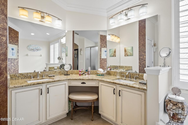 bathroom with tile patterned flooring, vanity, a shower with door, and crown molding