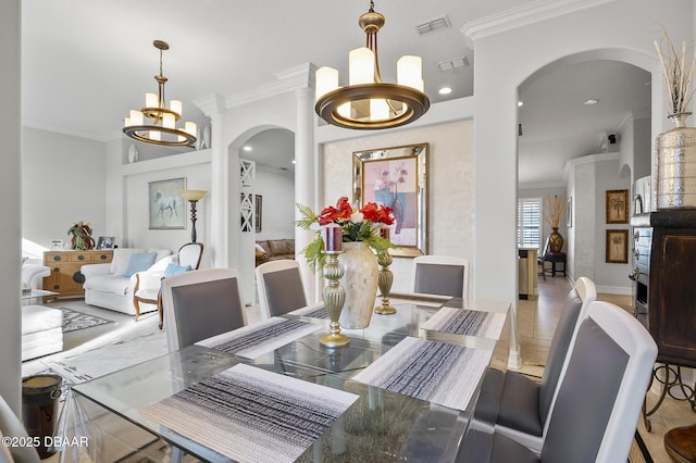 dining space featuring ornamental molding and a notable chandelier