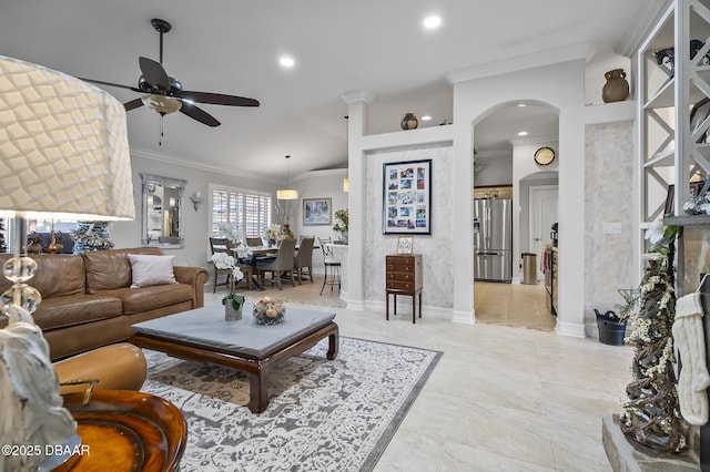 living room featuring ceiling fan and ornamental molding