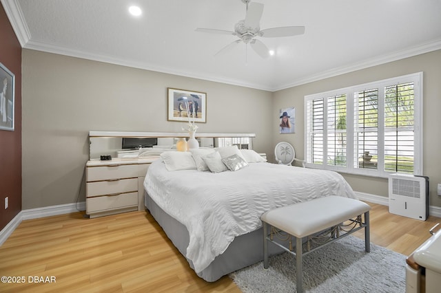 bedroom with ceiling fan, ornamental molding, and light hardwood / wood-style flooring