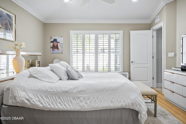 bedroom with ceiling fan, light hardwood / wood-style flooring, and crown molding