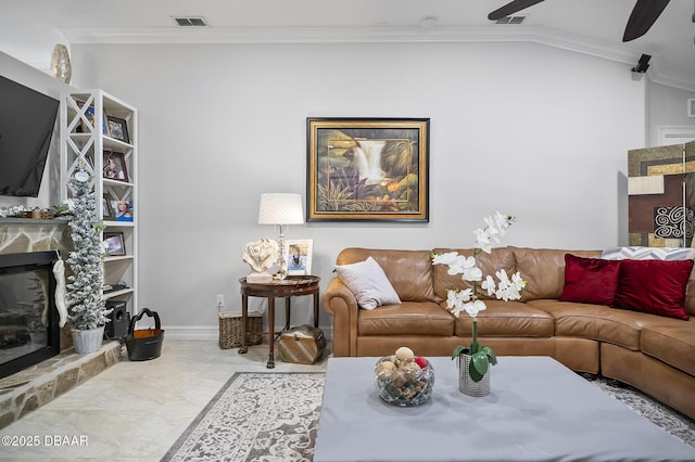 living room with ceiling fan, crown molding, a fireplace, and vaulted ceiling