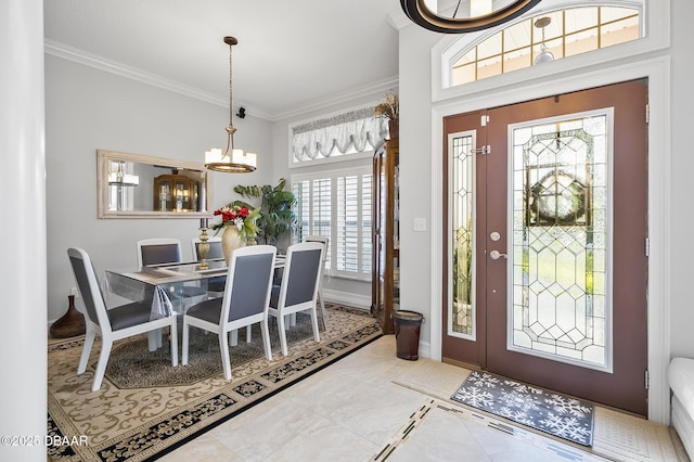 entrance foyer featuring tile patterned flooring, ornamental molding, a wealth of natural light, and a notable chandelier