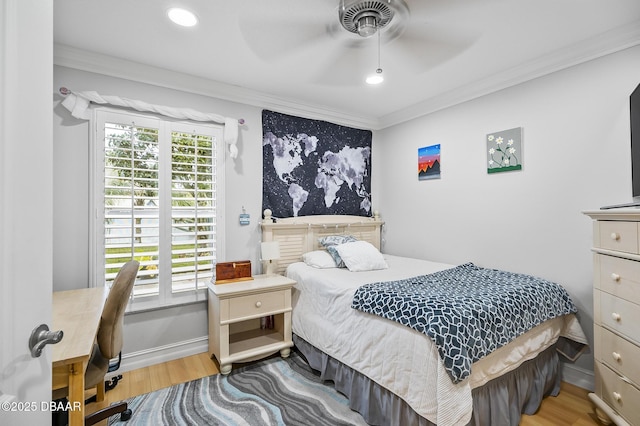 bedroom featuring ceiling fan, hardwood / wood-style floors, and crown molding