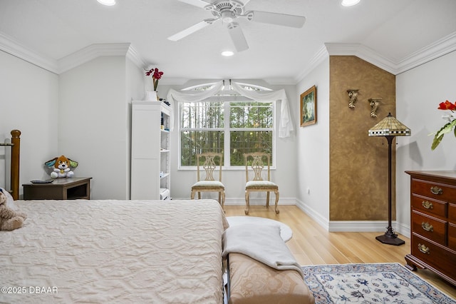 bedroom featuring hardwood / wood-style flooring, ceiling fan, and ornamental molding