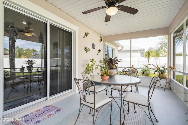 sunroom / solarium featuring ceiling fan