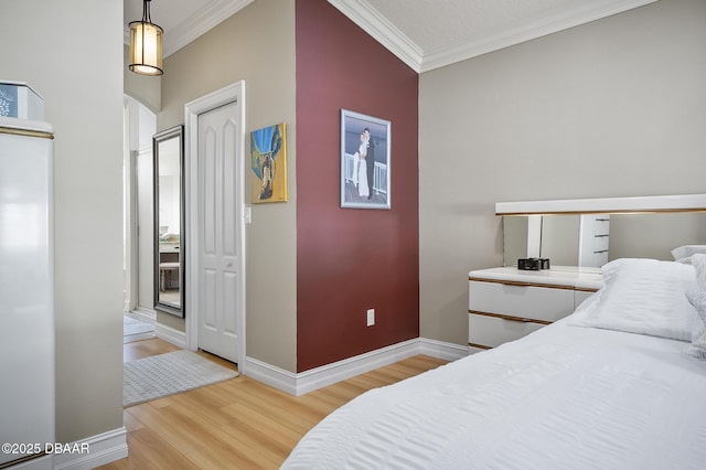 bedroom featuring a textured ceiling, wood-type flooring, and ornamental molding