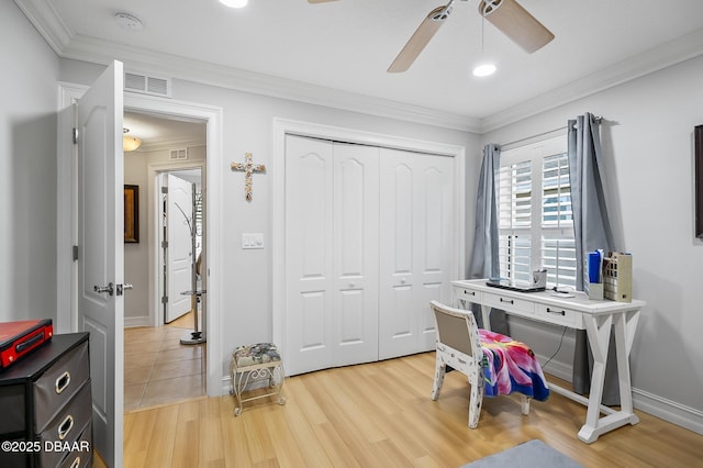 home office featuring ceiling fan, light hardwood / wood-style flooring, and crown molding