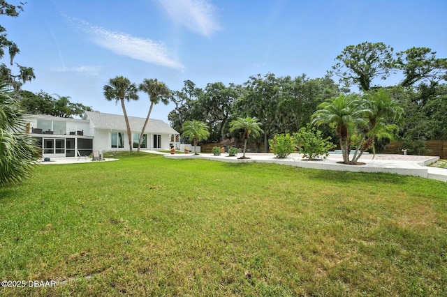 5540 W Bayshore Dr, Port Orange, FL 32127 - view of green lawn with a sunroom