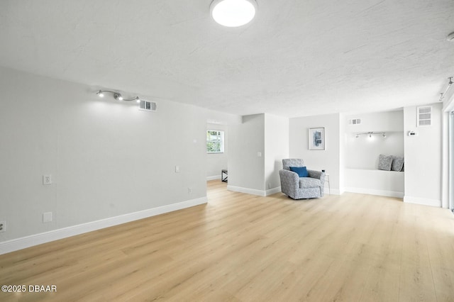 5540 W Bayshore Dr, Port Orange, FL 32127 - unfurnished living room featuring light wood finished floors and a textured ceiling