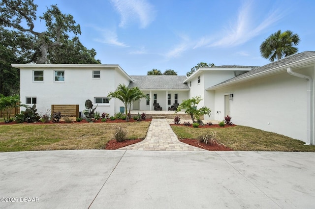 5540 W Bayshore Dr, Port Orange, FL 32127 - view of front of house featuring stucco siding and a front yard