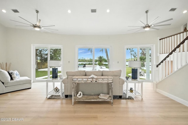 5540 W Bayshore Dr, Port Orange, FL 32127 - living area featuring a ceiling fan, wood finished floors, stairway, healthy amount of natural light, and recessed lighting