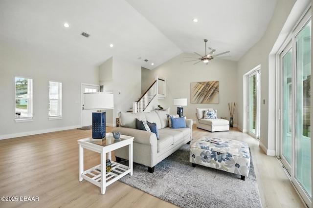 5540 W Bayshore Dr, Port Orange, FL 32127 - living room featuring light wood-style flooring, stairway, ceiling fan, recessed lighting, and high vaulted ceiling