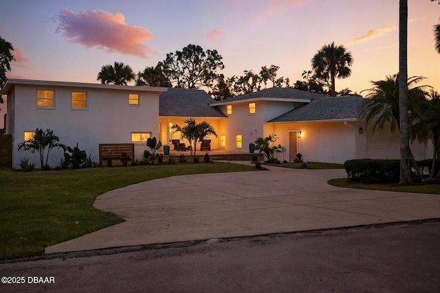 5540 W Bayshore Dr, Port Orange, FL 32127 - view of front of home featuring stucco siding, curved driveway, and a front yard