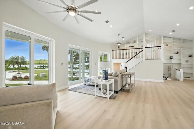 5540 W Bayshore Dr, Port Orange, FL 32127 - living room with ceiling fan, vaulted ceiling, light wood-style flooring, stairway, and recessed lighting