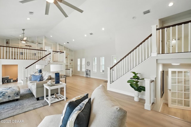5540 W Bayshore Dr, Port Orange, FL 32127 - living room featuring ceiling fan, stairs, high vaulted ceiling, wood finished floors, and recessed lighting