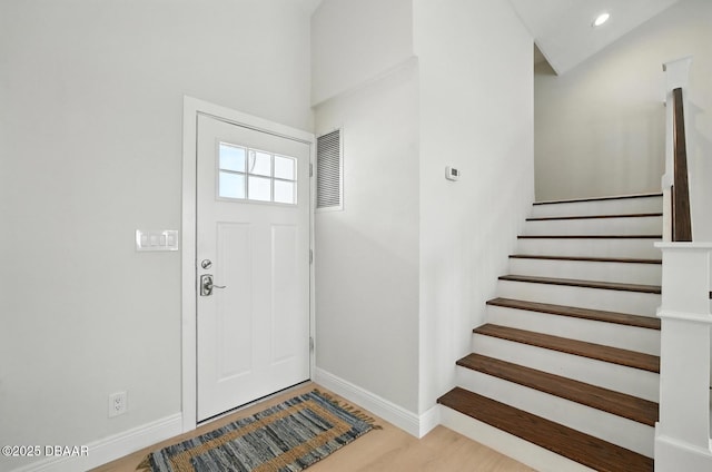 5540 W Bayshore Dr, Port Orange, FL 32127 - entryway with stairway, wood finished floors, and recessed lighting