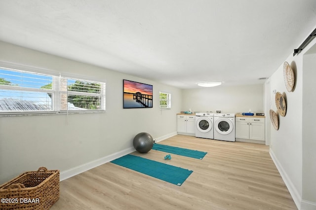 5540 W Bayshore Dr, Port Orange, FL 32127 - washroom with cabinet space, separate washer and dryer, and light wood finished floors