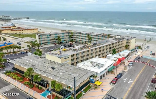 drone / aerial view featuring a beach view and a water view