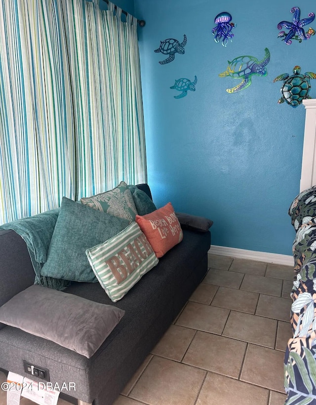 living room featuring tile patterned floors and baseboards