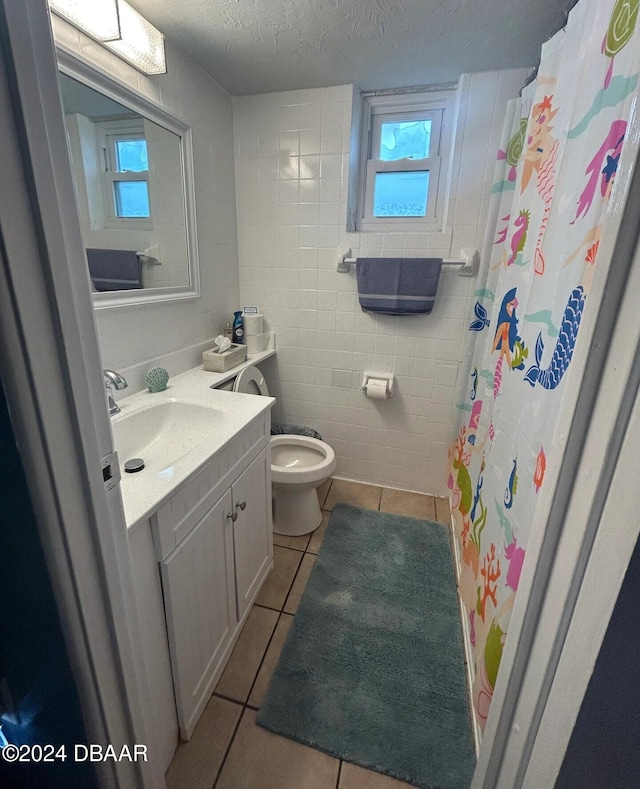full bathroom featuring toilet, tile patterned flooring, vanity, and plenty of natural light