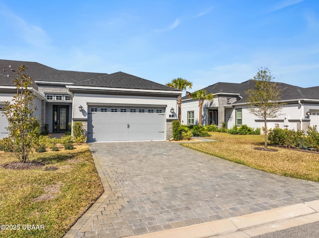 view of front of home featuring a garage and a front lawn